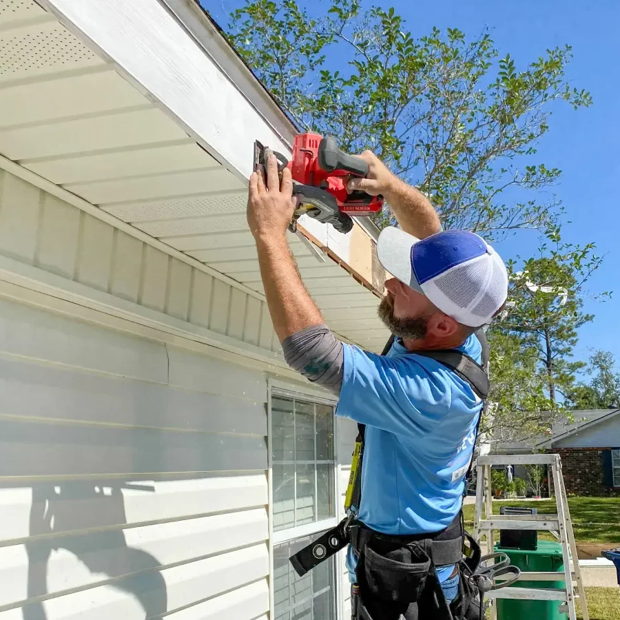 Faithful gutters repair technician repairing fascia board with battery powered circular saw